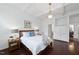 Comfortable main bedroom featuring hardwood floors, an ensuite bathroom and a built-in cabinet at 105 Sundew Ln, Cary, NC 27518