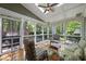 Inviting screened porch with wooden floors, cozy seating, and views of the lush surroundings at 105 Sundew Ln, Cary, NC 27518