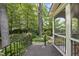 View of the screened porch with access to a landscaped garden and mature trees at 105 Sundew Ln, Cary, NC 27518