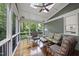 Charming screened porch featuring a ceiling fan, skylight and comfortable seating for outdoor enjoyment at 105 Sundew Ln, Cary, NC 27518