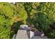 Aerial view showcasing a home's rooftop, nestled amid lush greenery at 106 Clendenen Ct, Cary, NC 27513