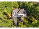 A high aerial shot of a sprawling home featuring mature landscaping and a paved driveway at 106 Clendenen Ct, Cary, NC 27513