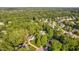 Aerial view of community surrounded by lush greenery with houses interspersed throughout the landscape at 106 Clendenen Ct, Cary, NC 27513
