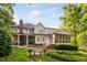 Expansive backyard featuring a covered patio, screened porch and serene greenery at 106 Clendenen Ct, Cary, NC 27513