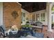 Comfortable covered patio with brick pillar, ceiling fan and outdoor seating area at 106 Clendenen Ct, Cary, NC 27513