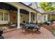 Spacious brick patio with ample seating, an outdoor dining set, and access to the serene backyard at 106 Clendenen Ct, Cary, NC 27513