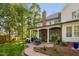 A beautiful backyard patio features a brick fireplace, ample seating and an outdoor dining area at 106 Clendenen Ct, Cary, NC 27513