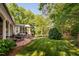 Secluded backyard with brick patio and lush landscaping, perfect for outdoor relaxation and entertaining at 106 Clendenen Ct, Cary, NC 27513