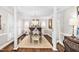 Formal dining room featuring hardwood floors, area rug, chandelier, and columns at 106 Clendenen Ct, Cary, NC 27513