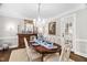 Elegant dining room featuring a chandelier, hardwood floors, classic furnishings and natural light at 106 Clendenen Ct, Cary, NC 27513