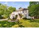 Elegant two-story brick home featuring an open balcony, fountain and lush landscaping at 106 Clendenen Ct, Cary, NC 27513