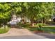 Charming white home with a well-maintained lawn and mature trees at 106 Clendenen Ct, Cary, NC 27513