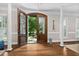 Inviting foyer featuring dark hardwood floors, a view to the fountain and elegant wall sconces at 106 Clendenen Ct, Cary, NC 27513