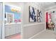 Hallway leading to the bathroom and sitting room; decorated with colorful modern wall art at 106 Clendenen Ct, Cary, NC 27513