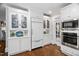 Well-lit kitchen with stainless steel appliances, hardwood floors, and white cabinetry at 106 Clendenen Ct, Cary, NC 27513