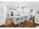 Spacious kitchen with white cabinets, hardwood floors, a center island and barstool seating at 106 Clendenen Ct, Cary, NC 27513