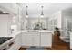 Spacious kitchen with white cabinets, quartz counters, and a center island at 106 Clendenen Ct, Cary, NC 27513