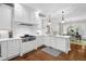 Kitchen featuring white cabinets, stainless appliances, and a view into the dining room at 106 Clendenen Ct, Cary, NC 27513