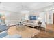 Cozy living room with hardwood floors, a ceiling fan, shutters and a neutral-toned couch at 106 Clendenen Ct, Cary, NC 27513