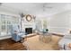 Inviting living room with fireplace, neutral-colored walls, hardwood floors and comfortable seating at 106 Clendenen Ct, Cary, NC 27513