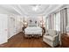 Sun-filled main bedroom boasts a four-poster bed and bright windows with shutter shades at 106 Clendenen Ct, Cary, NC 27513