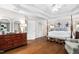 Elegant main bedroom with a four-poster bed, tray ceiling, and dark hardwood floors at 106 Clendenen Ct, Cary, NC 27513