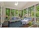 Relaxing porch with comfortable lounge seating and views of the lush backyard at 106 Clendenen Ct, Cary, NC 27513