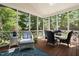 Cozy screened porch with dining and lounge seating, perfect for enjoying the outdoors with a view at 106 Clendenen Ct, Cary, NC 27513