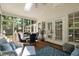 Relaxing screened porch with dining and lounge seating, perfect for enjoying the outdoors in any weather at 106 Clendenen Ct, Cary, NC 27513