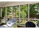 Comfortable porch seating with a view of the serene backyard, perfect for relaxing or entertaining at 106 Clendenen Ct, Cary, NC 27513