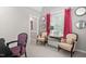 Bright sitting room with natural light, complemented by stylish seating and elegant decor at 106 Clendenen Ct, Cary, NC 27513