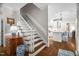 Inviting foyer with staircase leading to the upper level and an open view of the kitchen at 106 Clendenen Ct, Cary, NC 27513
