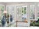 Bright sunroom featuring a doorway to the outdoor porch with comfortable seating and relaxing decor at 106 Clendenen Ct, Cary, NC 27513