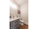 Well-lit powder room featuring modern vanity, stylish mirror, and a classic toilet at 107 N Guthrie Ave, Durham, NC 27703