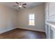 Empty bedroom with a ceiling fan, hardwood floors, and a bright window at 107 N Guthrie Ave, Durham, NC 27703