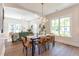 Open dining room featuring contemporary lighting and hardwood flooring and connection to living room at 107 N Guthrie Ave, Durham, NC 27703