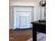 Close-up of a decorative white fireplace with intricate patterns and a dark hearth at 107 N Guthrie Ave, Durham, NC 27703