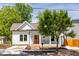 Charming cottage-style home with a covered front porch and vibrant orange front door at 107 N Guthrie Ave, Durham, NC 27703