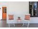 Front porch shows modern outdoor seating with orange accents next to the door at 107 N Guthrie Ave, Durham, NC 27703