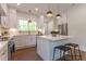 Charming kitchen featuring white cabinets, stainless steel appliances, and a center island with seating at 107 N Guthrie Ave, Durham, NC 27703