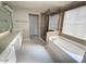 Bathroom featuring double sink vanity, large soaking tub, and glass shower at 110 Bristolwood Cir, Morrisville, NC 27560
