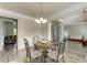 Elegant dining area with decorative chandelier and easy access to adjacent living spaces at 110 Bristolwood Cir, Morrisville, NC 27560