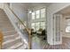 Bright foyer with a staircase, large windows, and an open floor plan into the living area at 110 Bristolwood Cir, Morrisville, NC 27560