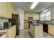 Modern kitchen featuring an island, granite countertops, and a black appliance package at 110 Bristolwood Cir, Morrisville, NC 27560