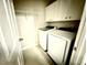 Convenient laundry room featuring a washer, dryer and overhead shelving at 110 Bristolwood Cir, Morrisville, NC 27560