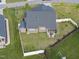 Aerial view of a well-maintained backyard with a fenced-in yard and a patio at 110 Deacon Ridge Ln, Youngsville, NC 27596