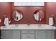 Bathroom featuring double vanity with round mirrors and a marble countertop at 110 Deacon Ridge Ln, Youngsville, NC 27596
