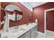 Modern bathroom featuring a double vanity with round mirrors and a marble countertop at 110 Deacon Ridge Ln, Youngsville, NC 27596