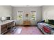 Bedroom with a desk, a daybed, and two windows offering views of the yard at 110 Deacon Ridge Ln, Youngsville, NC 27596