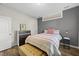 Bedroom featuring a large window, bedside table, and stylish dresser at 110 Deacon Ridge Ln, Youngsville, NC 27596